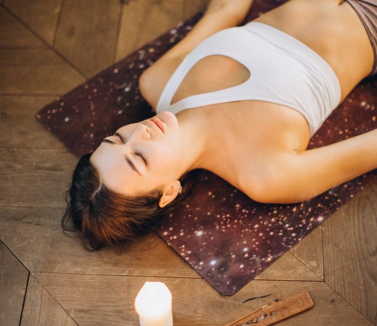 woman lying down in savasana